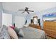 Bright bedroom with ceiling fan, large bed, and double closet at 9000 Griggs Rd # G, Englewood, FL 34224