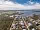 An aerial view showcasing a waterfront house's location in a residential area at 9240 Pine Cove Dr, Englewood, FL 34224