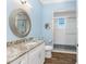 Charming bathroom with granite countertop and walk-in shower at 9240 Pine Cove Dr, Englewood, FL 34224