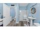 Clean bathroom with walk-in shower, pedestal sink, and wood-look tile floor at 9240 Pine Cove Dr, Englewood, FL 34224