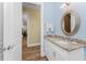 Clean bathroom with granite vanity and a view to the dining area at 9240 Pine Cove Dr, Englewood, FL 34224