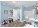 Spa-like bathroom with walk-in shower, pedestal sink, and wood-look tile floor at 9240 Pine Cove Dr, Englewood, FL 34224