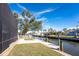 Scenic waterfront view with a private dock and lush green landscaping at 9240 Pine Cove Dr, Englewood, FL 34224