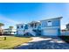 Two-story light blue house with white trim, two-car garage, and a paved driveway at 9240 Pine Cove Dr, Englewood, FL 34224