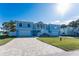 Two-story light blue house with white trim, two-car garage, and a paved driveway at 9240 Pine Cove Dr, Englewood, FL 34224