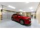 Bright garage with a red SUV and room for additional vehicles at 9240 Pine Cove Dr, Englewood, FL 34224