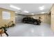 Modern garage with a black SUV, storage, and a high-quality floor at 9240 Pine Cove Dr, Englewood, FL 34224