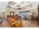 Living room with hardwood floors, coffered ceiling, and leather sofas at 9240 Pine Cove Dr, Englewood, FL 34224