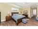 Main bedroom with hardwood floors and access to private balcony at 9240 Pine Cove Dr, Englewood, FL 34224