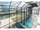 Stunning view of a screened pool and spa area at 9240 Pine Cove Dr, Englewood, FL 34224