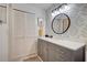 Updated bathroom with gray vanity, quartz countertop, and patterned wallpaper at 93 Boundary Blvd # 301, Rotonda West, FL 33947