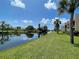 Serene canal-front view with lush landscaping at 93 Boundary Blvd # 301, Rotonda West, FL 33947