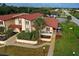 Aerial view showing the home's exterior, landscaping, and walkway at 93 Boundary Blvd # 301, Rotonda West, FL 33947