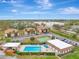 Aerial view of condo community with pool, shuffleboard, and parking at 1 Quails Run Blvd # 5, Englewood, FL 34223