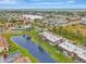Aerial view of condo community near the water, showing surrounding area at 1 Quails Run Blvd # 5, Englewood, FL 34223