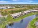 Aerial view of condo community, highlighting its location near water at 1 Quails Run Blvd # 5, Englewood, FL 34223
