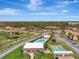 Aerial view of community with pool, shuffleboard, and buildings at 1 Quails Run Blvd # 5, Englewood, FL 34223