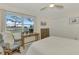 Relaxing bedroom with a comfortable bed, rocking chair, and a writing desk at 1 Quails Run Blvd # 5, Englewood, FL 34223