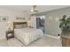 Cozy bedroom with a queen bed, sliding door access, and wood accent wall at 1 Quails Run Blvd # 5, Englewood, FL 34223