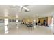 Community room with tables, chairs, and bookcases at 1 Quails Run Blvd # 5, Englewood, FL 34223