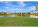 Tranquil waterfront view of condo community with manicured lawns at 1 Quails Run Blvd # 5, Englewood, FL 34223