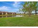 Picturesque waterfront view of condo community with a pond at 1 Quails Run Blvd # 5, Englewood, FL 34223