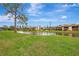 Waterfront community view with lush green space and condo buildings at 1 Quails Run Blvd # 5, Englewood, FL 34223