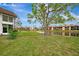 Community view with pond and lush landscaping at 1 Quails Run Blvd # 5, Englewood, FL 34223