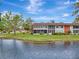 Condo building exterior with screened porch overlooking a canal at 1 Quails Run Blvd # 5, Englewood, FL 34223