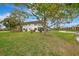 Condo building exterior with a pond view and lush landscaping at 1 Quails Run Blvd # 5, Englewood, FL 34223
