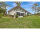 Condo building exterior showcasing screened balconies and landscaping at 1 Quails Run Blvd # 5, Englewood, FL 34223
