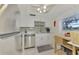 Modern kitchen with white cabinets, stainless steel appliances, and granite countertops at 1 Quails Run Blvd # 5, Englewood, FL 34223
