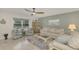 Bright living room with comfy sofas, a coffee table, and tiled floors at 1 Quails Run Blvd # 5, Englewood, FL 34223