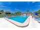 Community pool with ample lounge chairs at 1 Quails Run Blvd # 5, Englewood, FL 34223