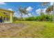 Large backyard with grassy area and mature trees at 11247 Euler Ave, Englewood, FL 34224