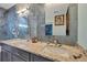 Bathroom with granite countertop, double vanity, and blue marble tile at 11247 Euler Ave, Englewood, FL 34224