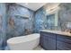Bathroom with freestanding bathtub and blue marble tile at 11247 Euler Ave, Englewood, FL 34224
