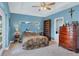 Bedroom with camouflage bedding and built-in wooden dresser at 11247 Euler Ave, Englewood, FL 34224