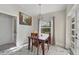 Bright dining room with a wooden table and four chairs, overlooking backyard at 11247 Euler Ave, Englewood, FL 34224