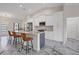 Modern kitchen featuring white cabinets, granite counters, and a large island at 11247 Euler Ave, Englewood, FL 34224