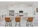 Modern kitchen with white cabinets, granite island, and stainless steel appliances at 11247 Euler Ave, Englewood, FL 34224