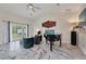 Spacious living room with marble floors, a grand piano, and comfy seating at 11247 Euler Ave, Englewood, FL 34224