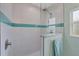 Walk-in shower with teal tile and glass enclosure at 11247 Euler Ave, Englewood, FL 34224
