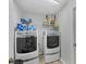 Laundry room with washer, dryer, and shelving for storage at 11353 Willmington Blvd, Port Charlotte, FL 33981