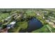 Aerial view of houses and a golf course near a lake at 1169 Boundary Blvd, Rotonda West, FL 33947