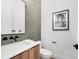Modern powder room with herringbone tile and floating vanity at 1169 Boundary Blvd, Rotonda West, FL 33947