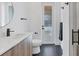 Clean bathroom with a floating vanity, toilet and a large mirror at 1169 Boundary Blvd, Rotonda West, FL 33947