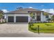 Two-story home with a large driveway and landscaped yard at 1169 Boundary Blvd, Rotonda West, FL 33947