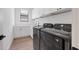 Laundry room with modern washer and dryer and white cabinets at 1169 Boundary Blvd, Rotonda West, FL 33947