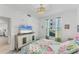 Bedroom with TV, dresser, and queen-size bed with colorful bedding at 12390 Wellen Golf St # 108, Venice, FL 34293